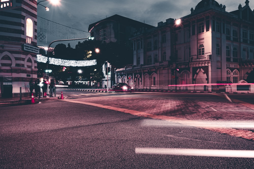 a city street at night with a traffic light