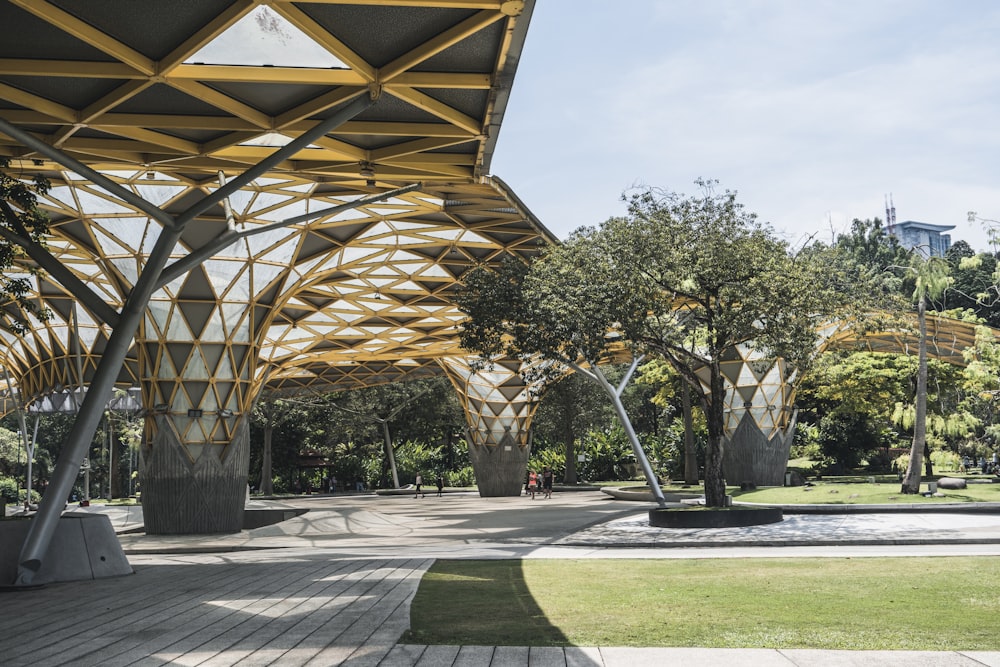 a walkway with a wooden structure and trees in the background