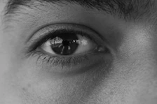 a black and white photo of a man's eye
