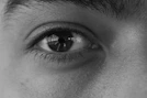 a black and white photo of a man's eye