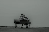 An elderly couple enjoying a peaceful moment together with a caregiver nearby