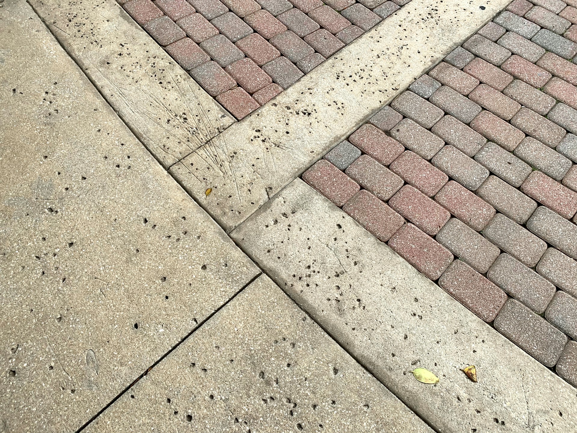 a red fire hydrant sitting on the side of a sidewalk