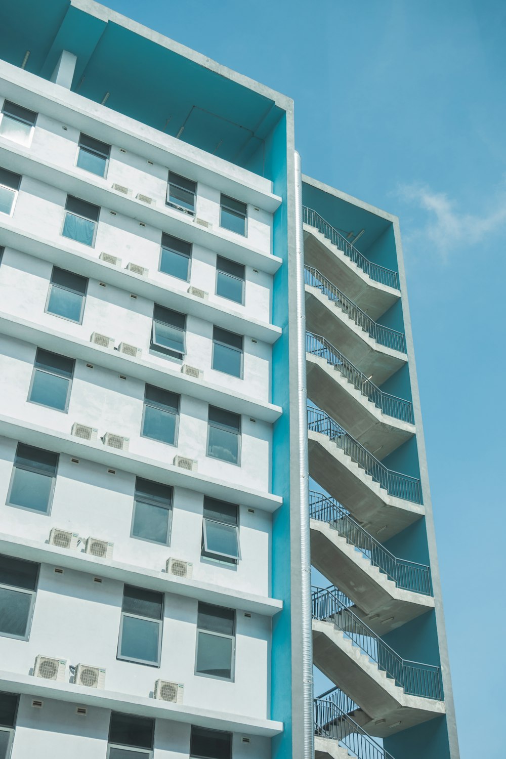 a tall white building with balconies and balconies