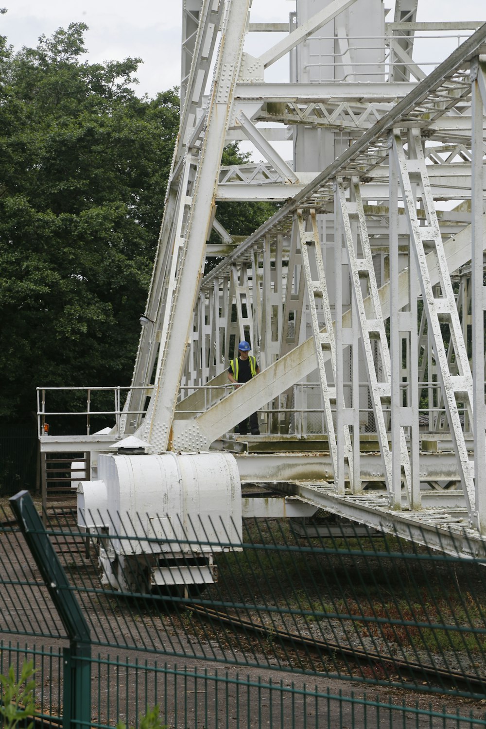 a man standing on top of a metal structure