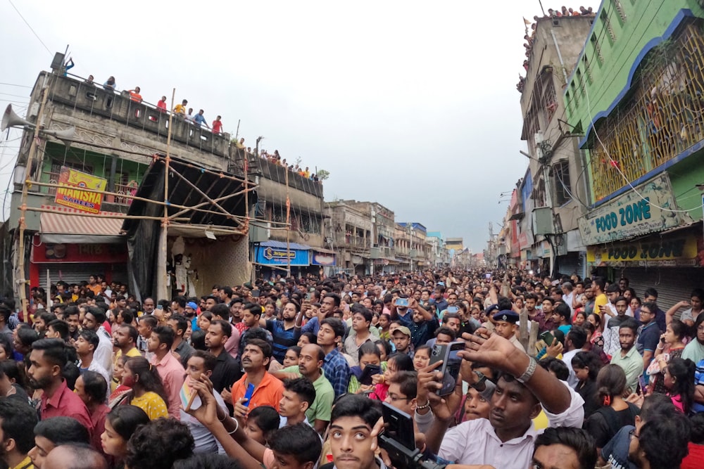 a large crowd of people standing in a street
