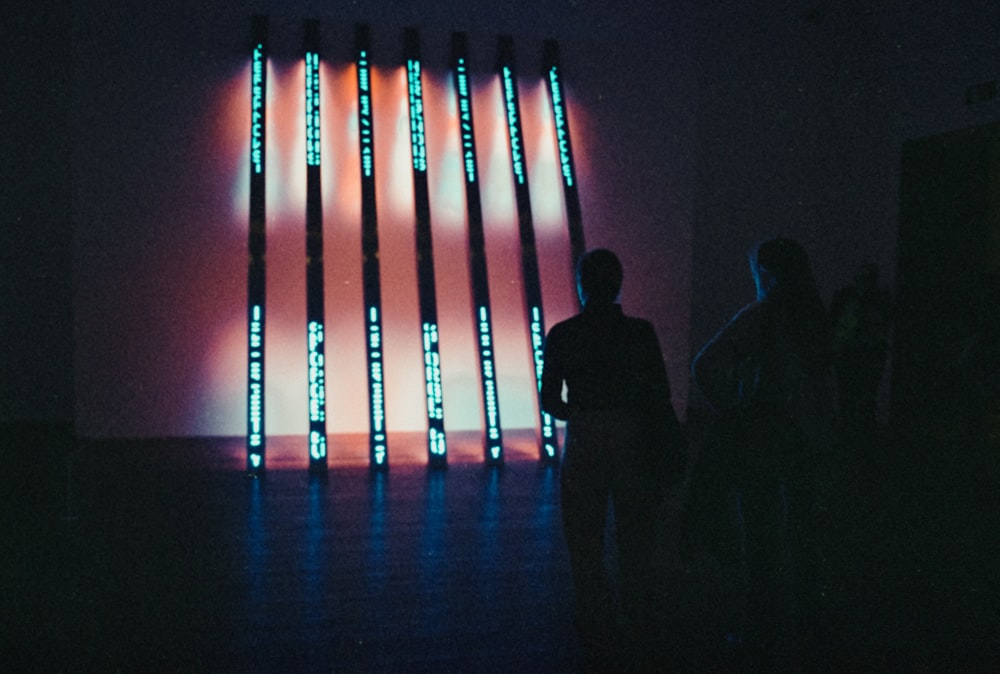 a group of people standing in a dark room