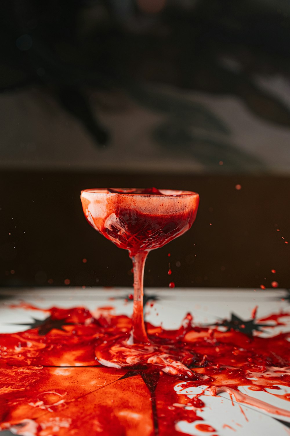a red liquid pouring into a wine glass