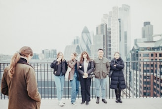 a group of people standing on top of a building