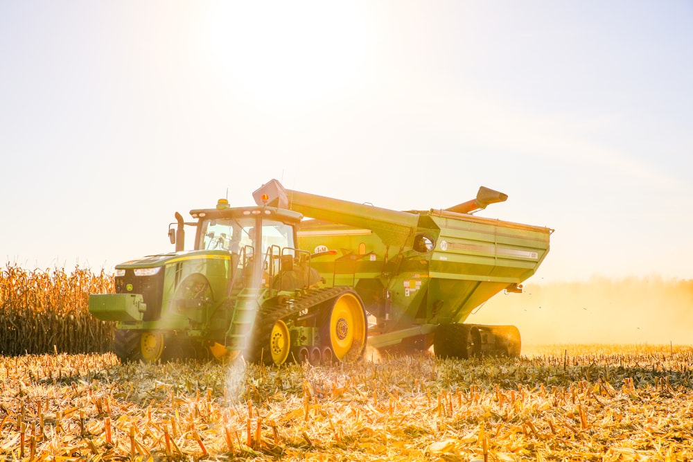 a tractor is driving through a corn field