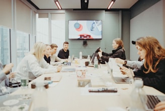 a group of people sitting around a conference table