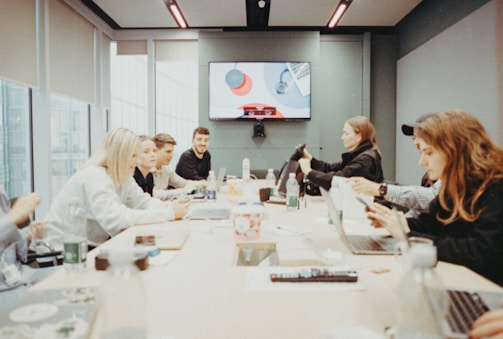 a group of people sitting around a conference table