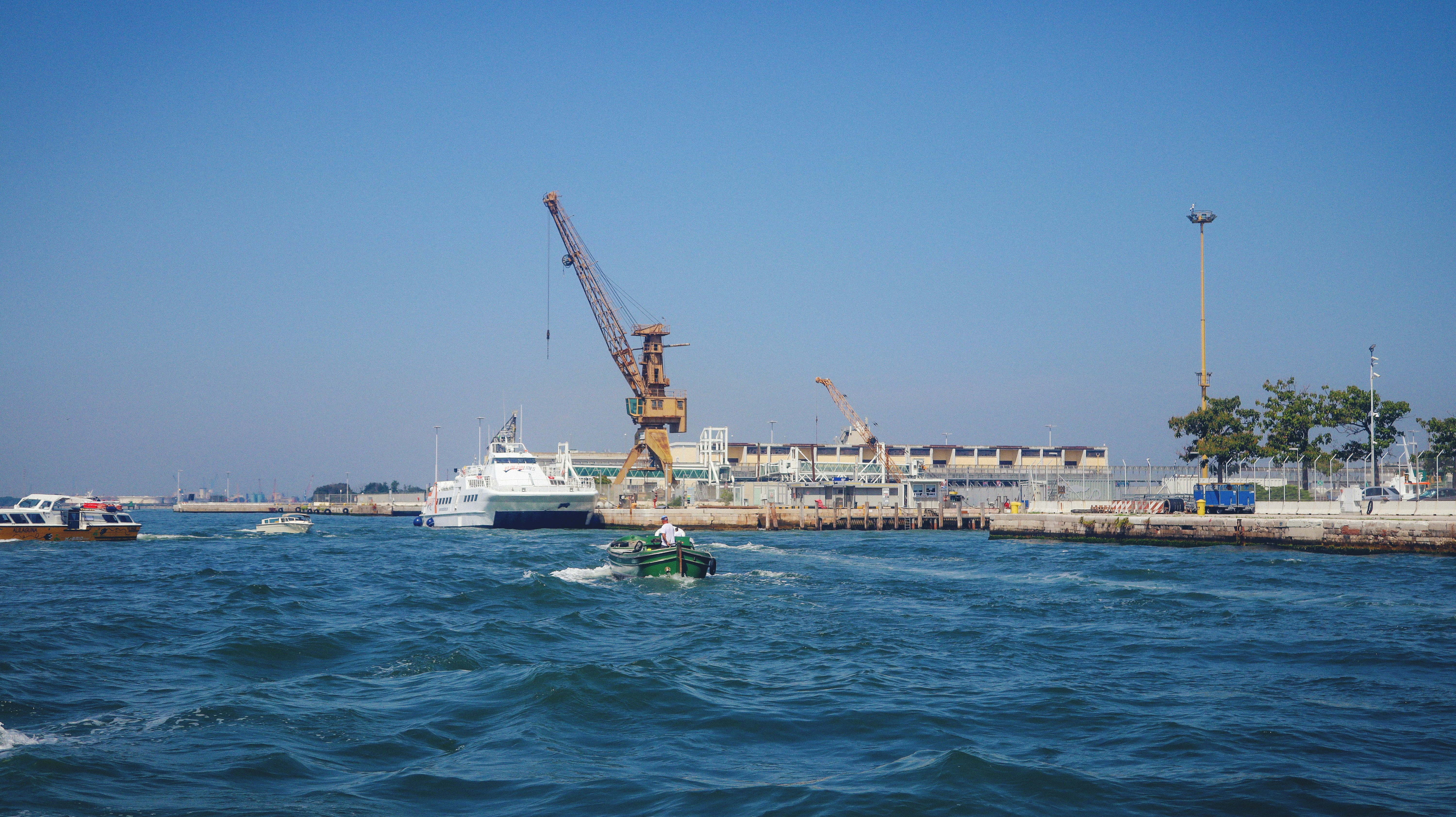 a boat in the water with a crane in the background