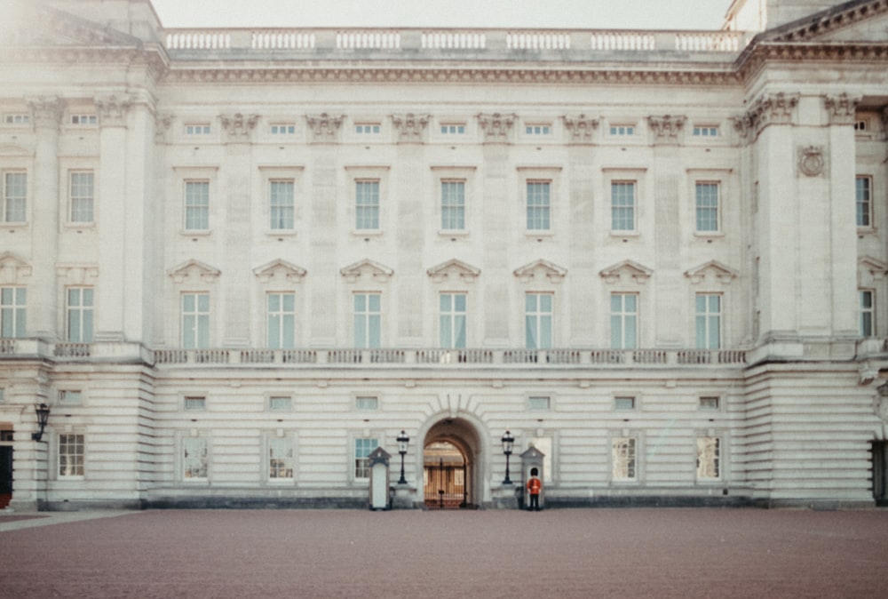 a large white building with a clock on the front of it