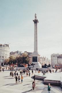 a group of people walking around a city square