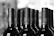 Close-up of wine bottles being carefully labeled and prepared for bottling.