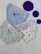 Three pairs of children's underwear are laid out on a flat surface. The underwear has playful designs featuring cartoon characters and patterns. There are three large purple circles placed next to the underwear.