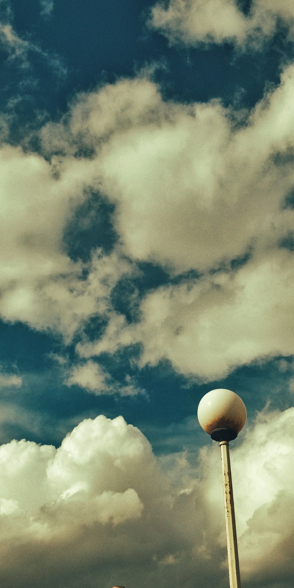 a tall white ball sitting on top of a metal pole