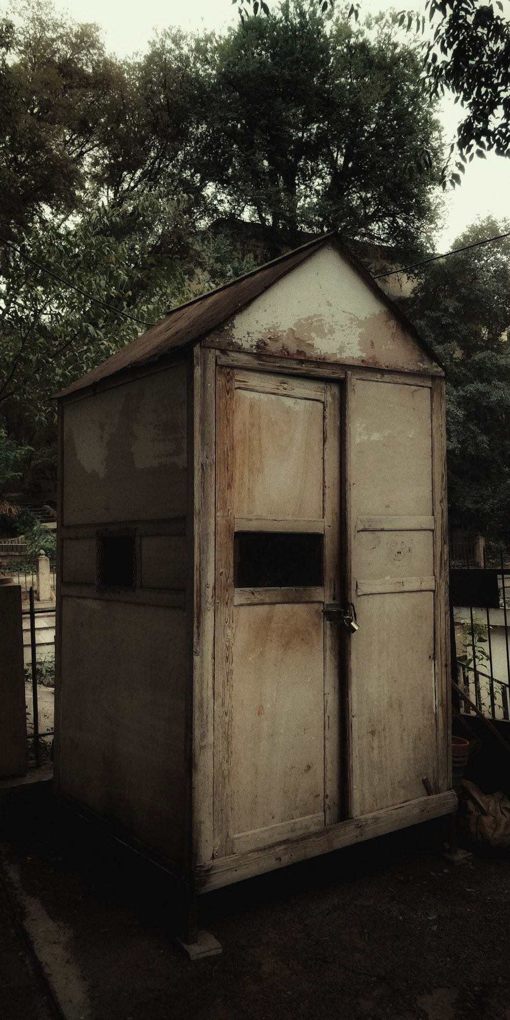 an old outhouse sitting in the middle of a field