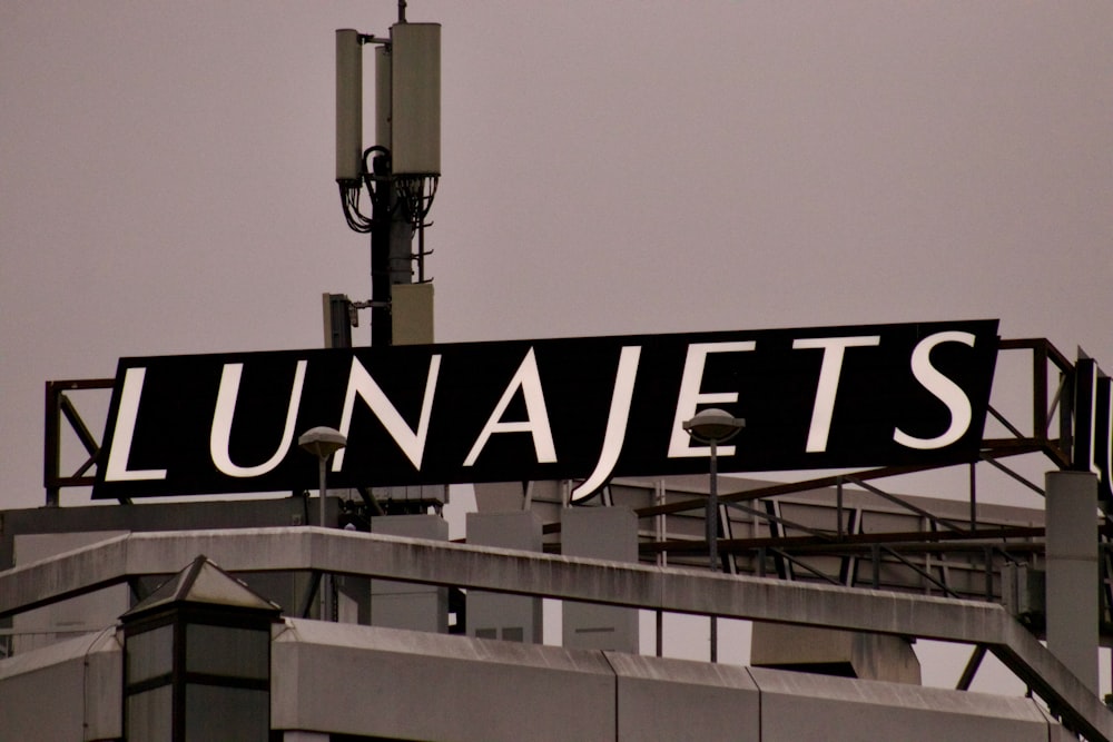 a street sign on top of a tall building