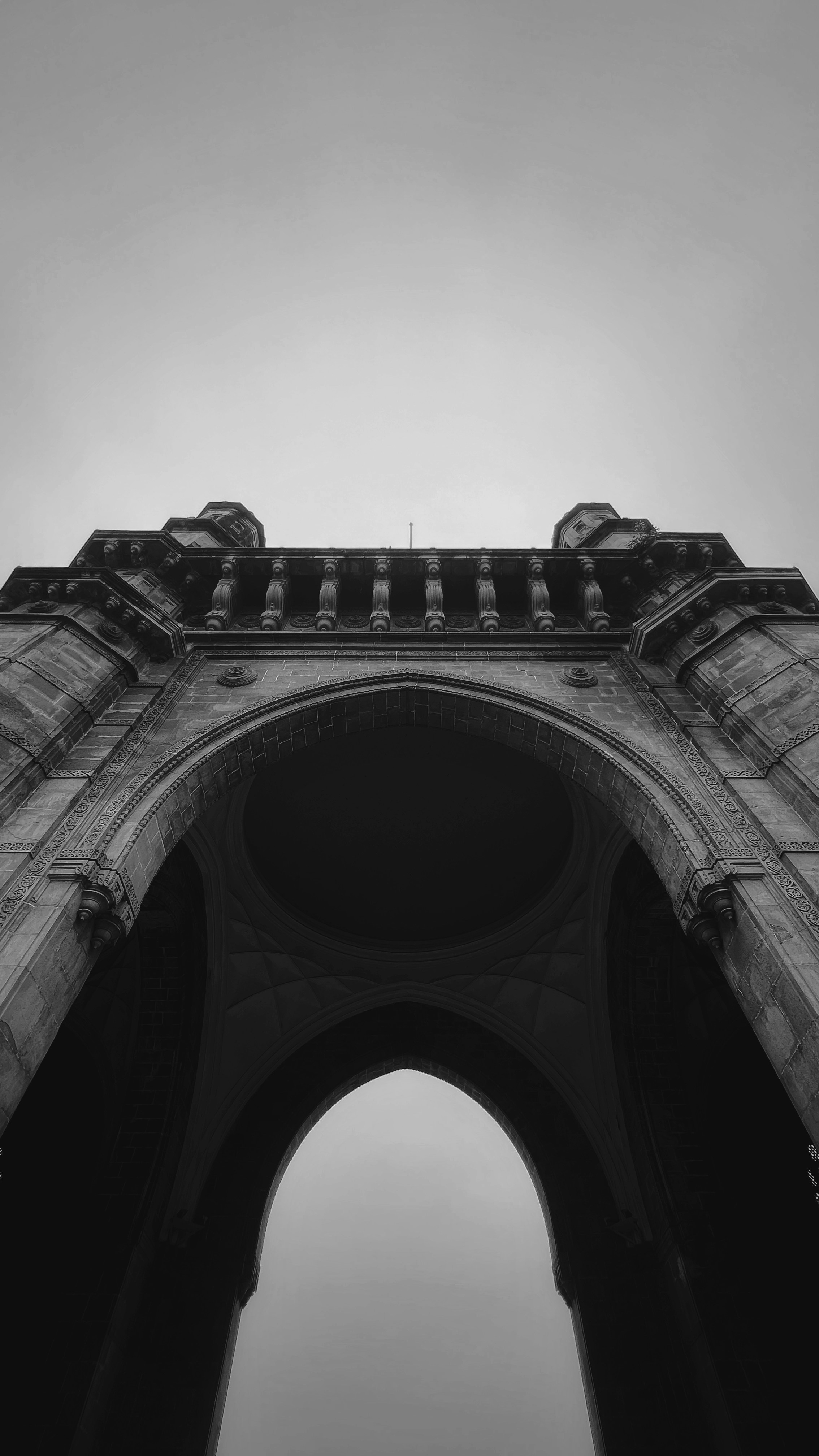a black and white photo of a stone arch