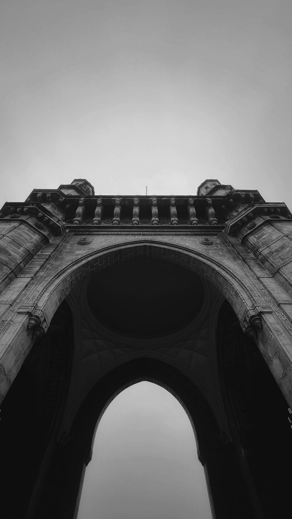 a black and white photo of a stone arch