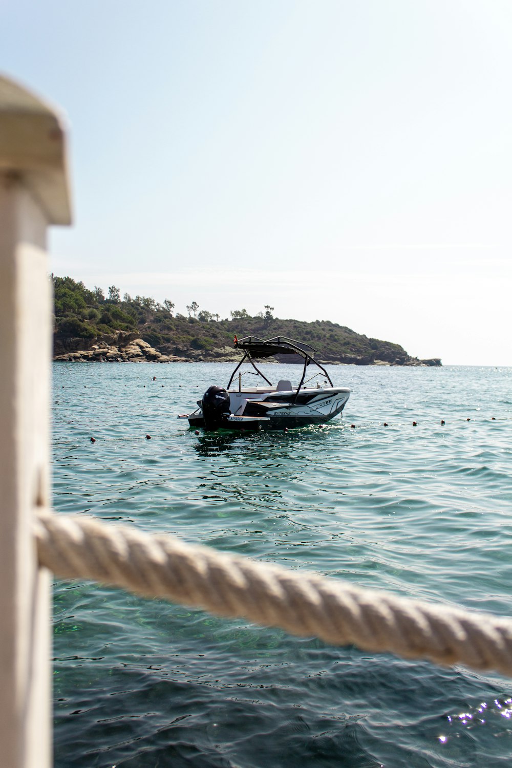 a small boat in the middle of a body of water