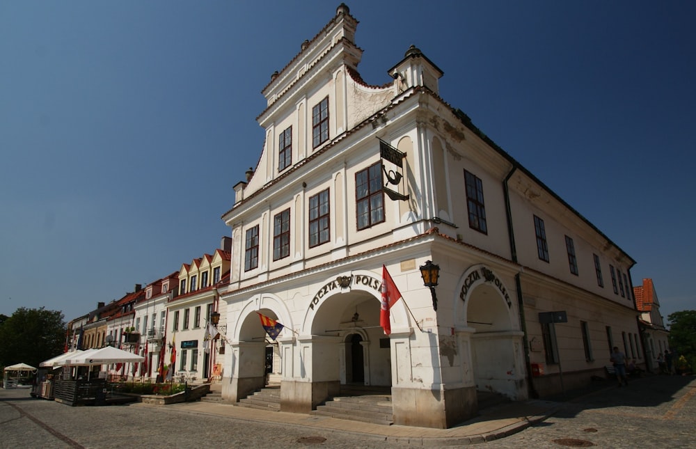 a large white building sitting on the side of a road