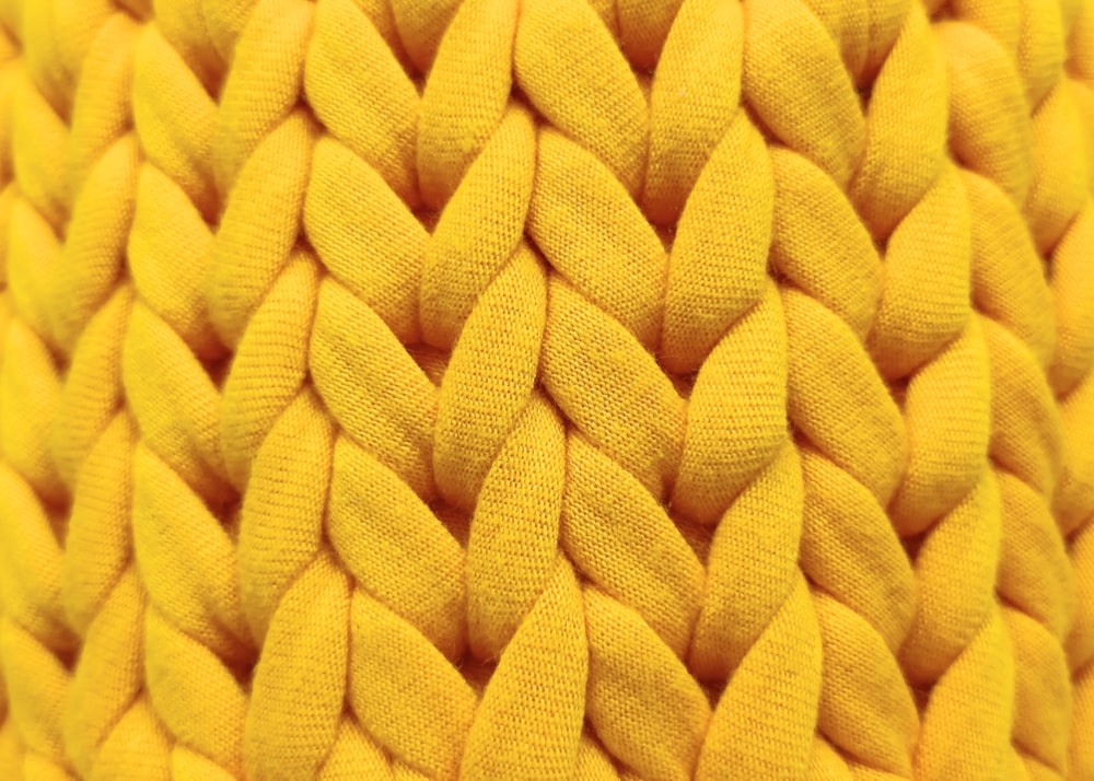 a close up of a yellow knitted material