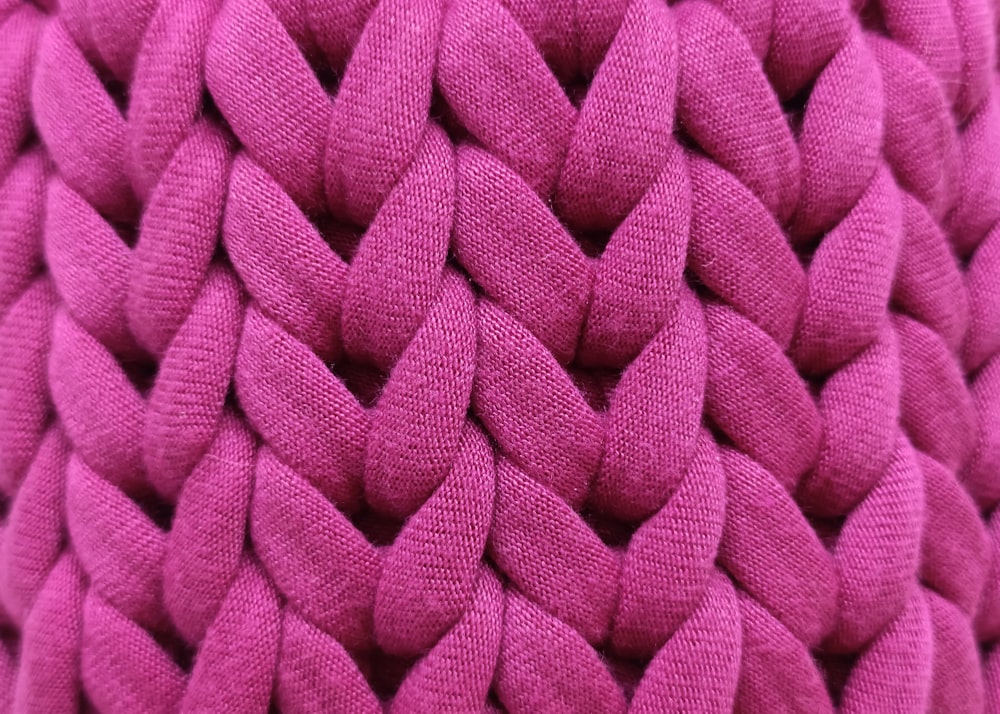 a close up of a pink knitted object