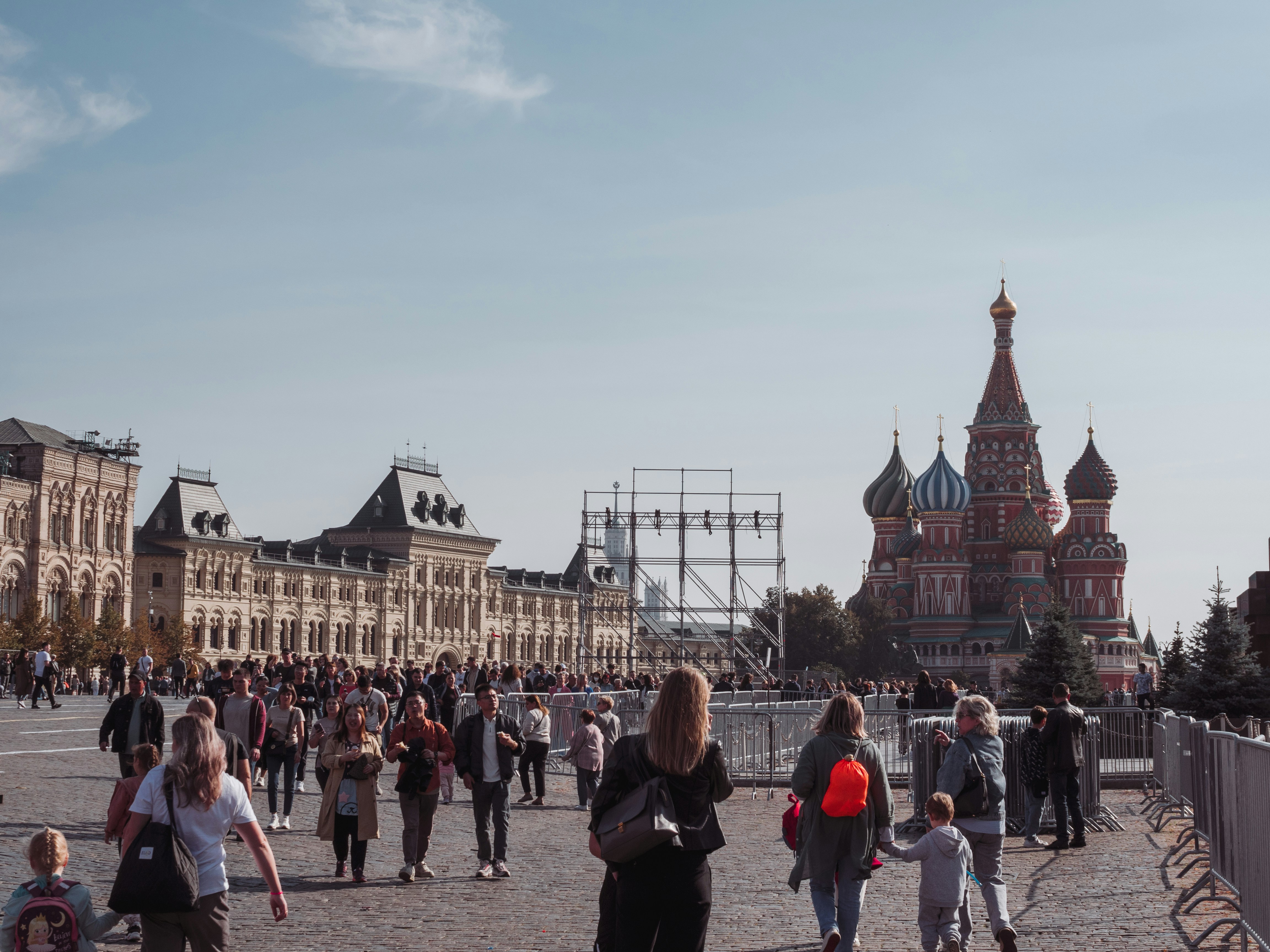 a group of people walking around a city