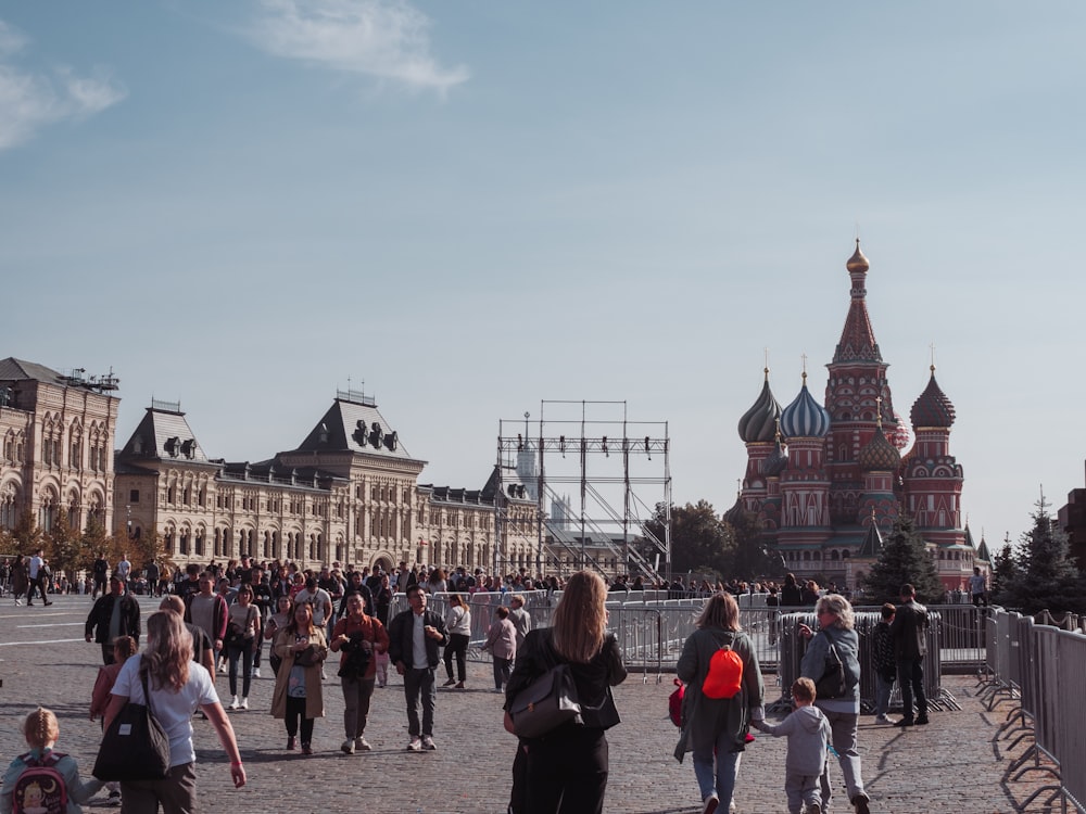 a group of people walking around a city