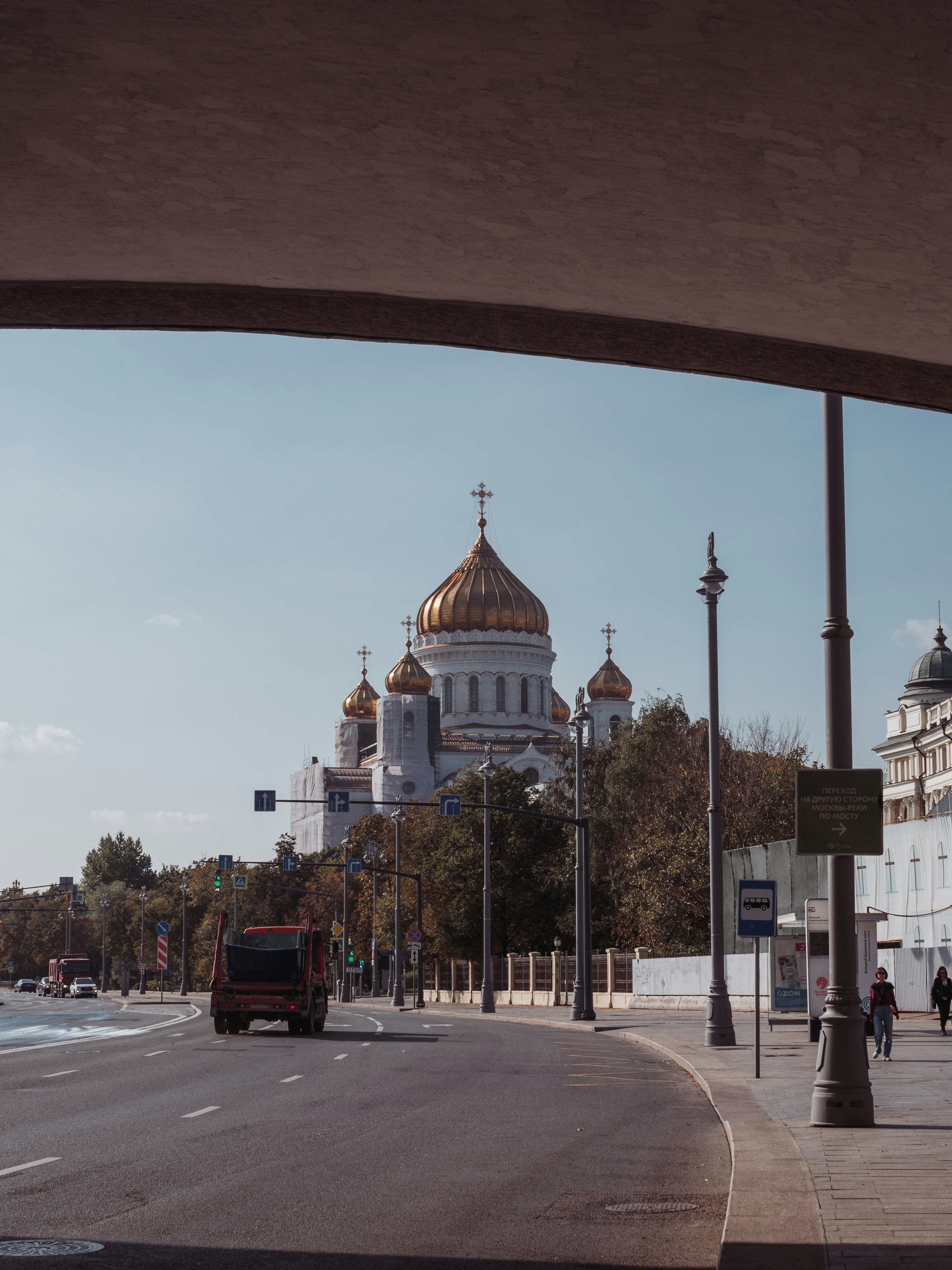 a bus driving down a street next to a tall building