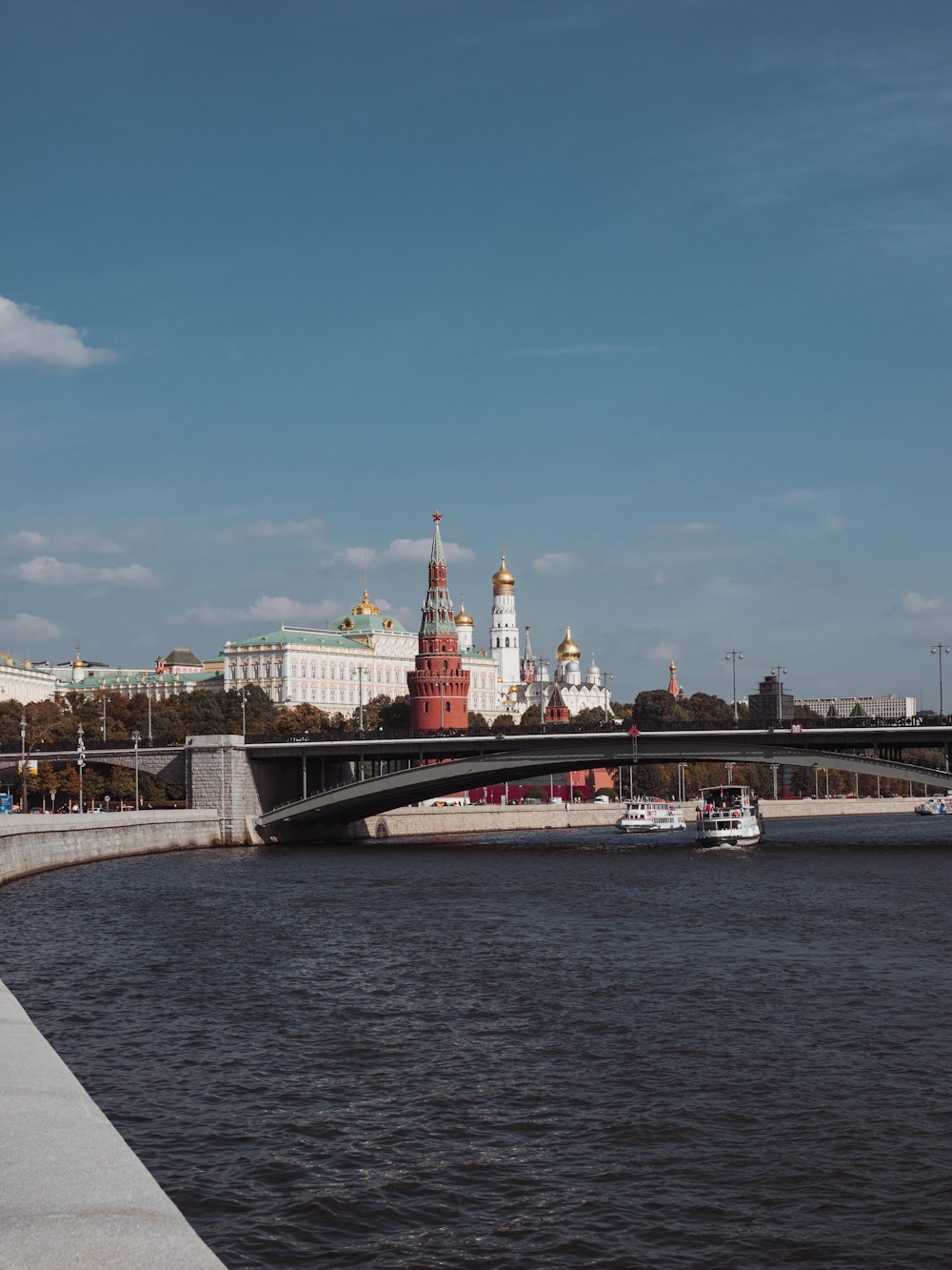 a bridge over a body of water with a building in the background