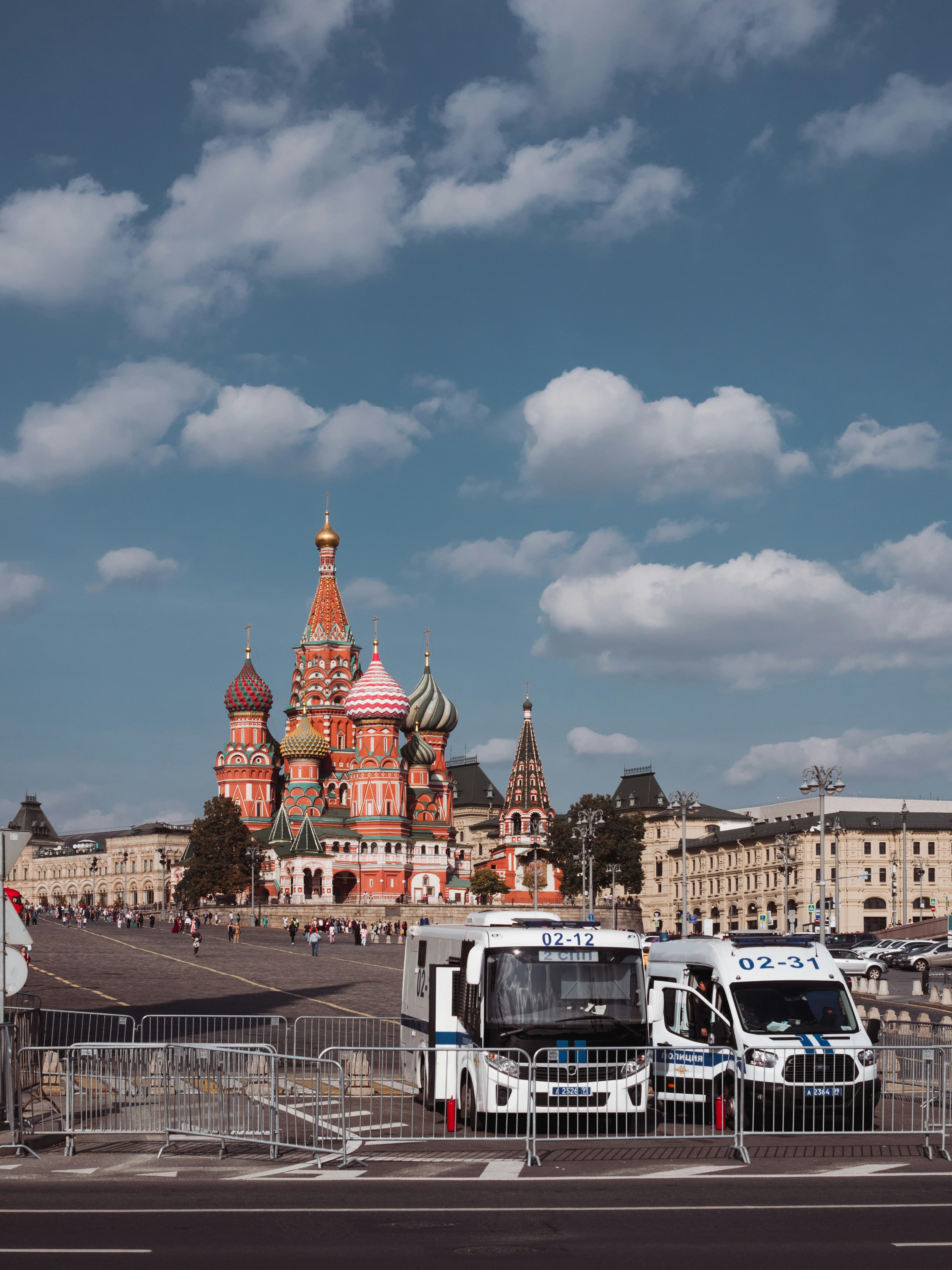 two buses parked next to each other in front of a building