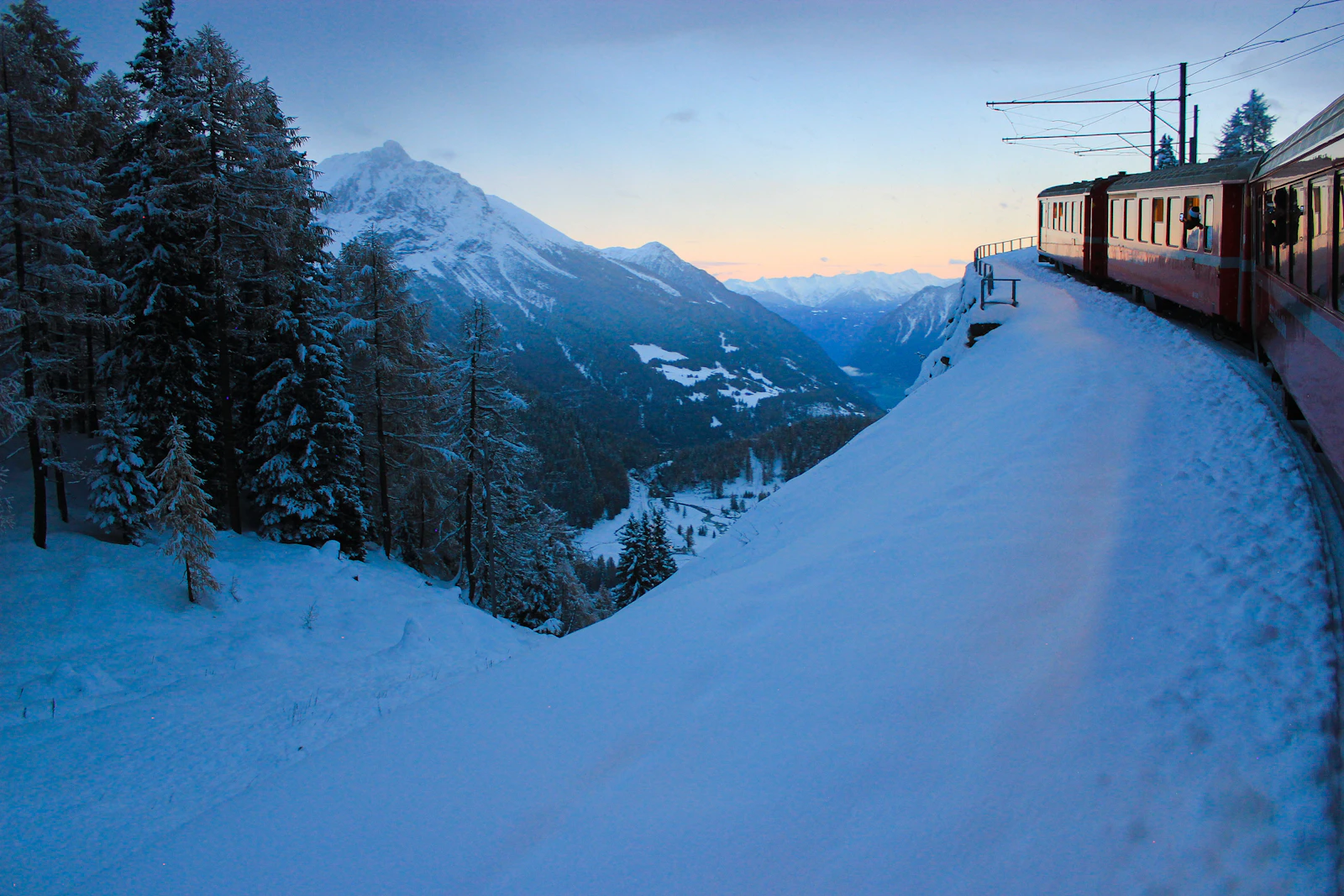 A snow covered Swiss alpine town beneath high winter peaks