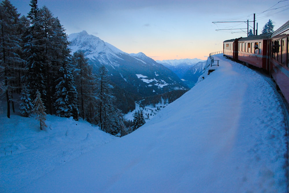 a train traveling through a snow covered mountain side