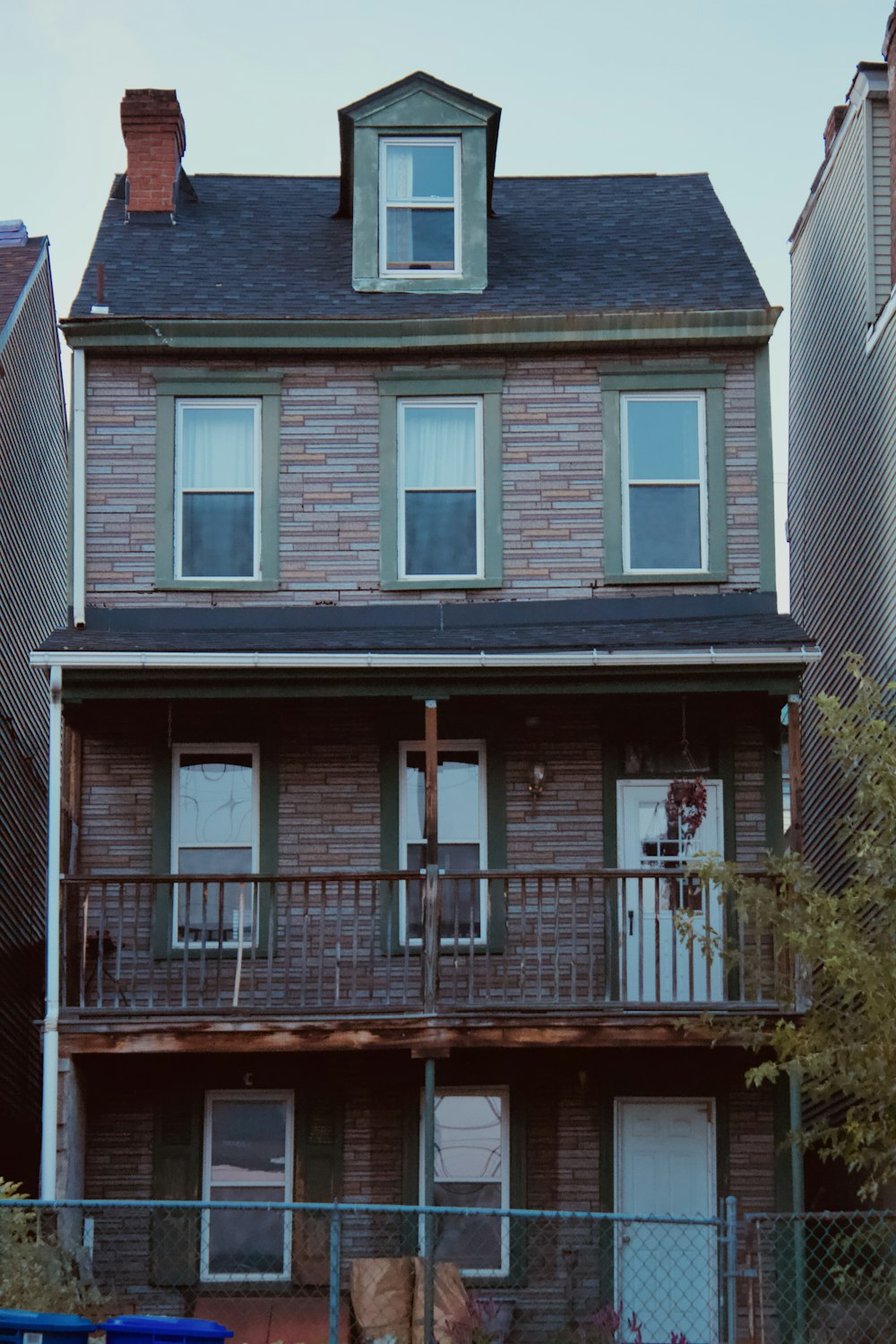 a tall brick building with a fence around it