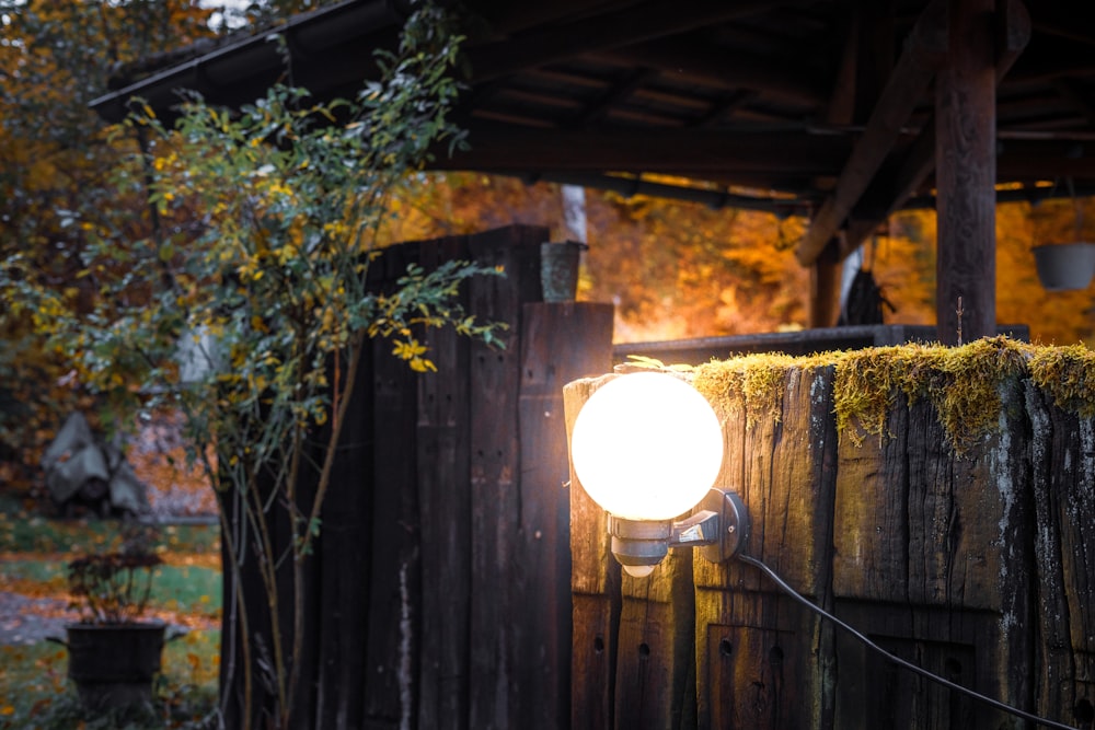 a light that is on a wooden fence