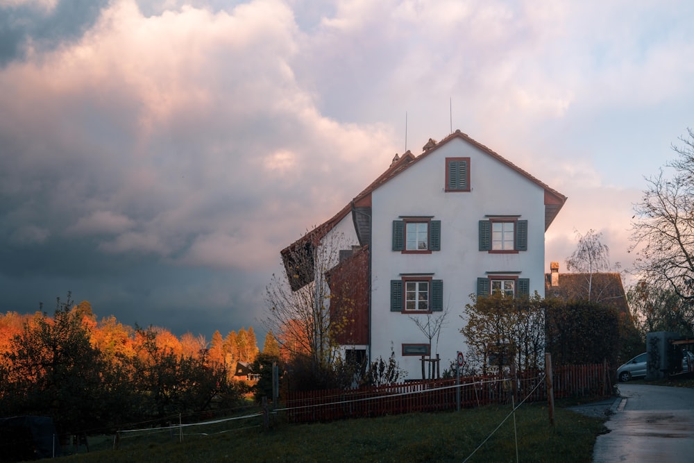 a large white house with a red roof