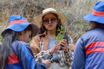 Volunteers planting trees on a sunny day as part of a local environmental project.