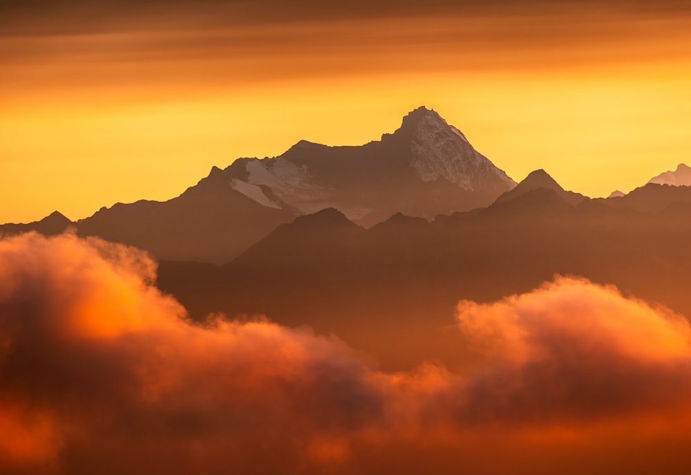 a view of the top of a mountain in the clouds