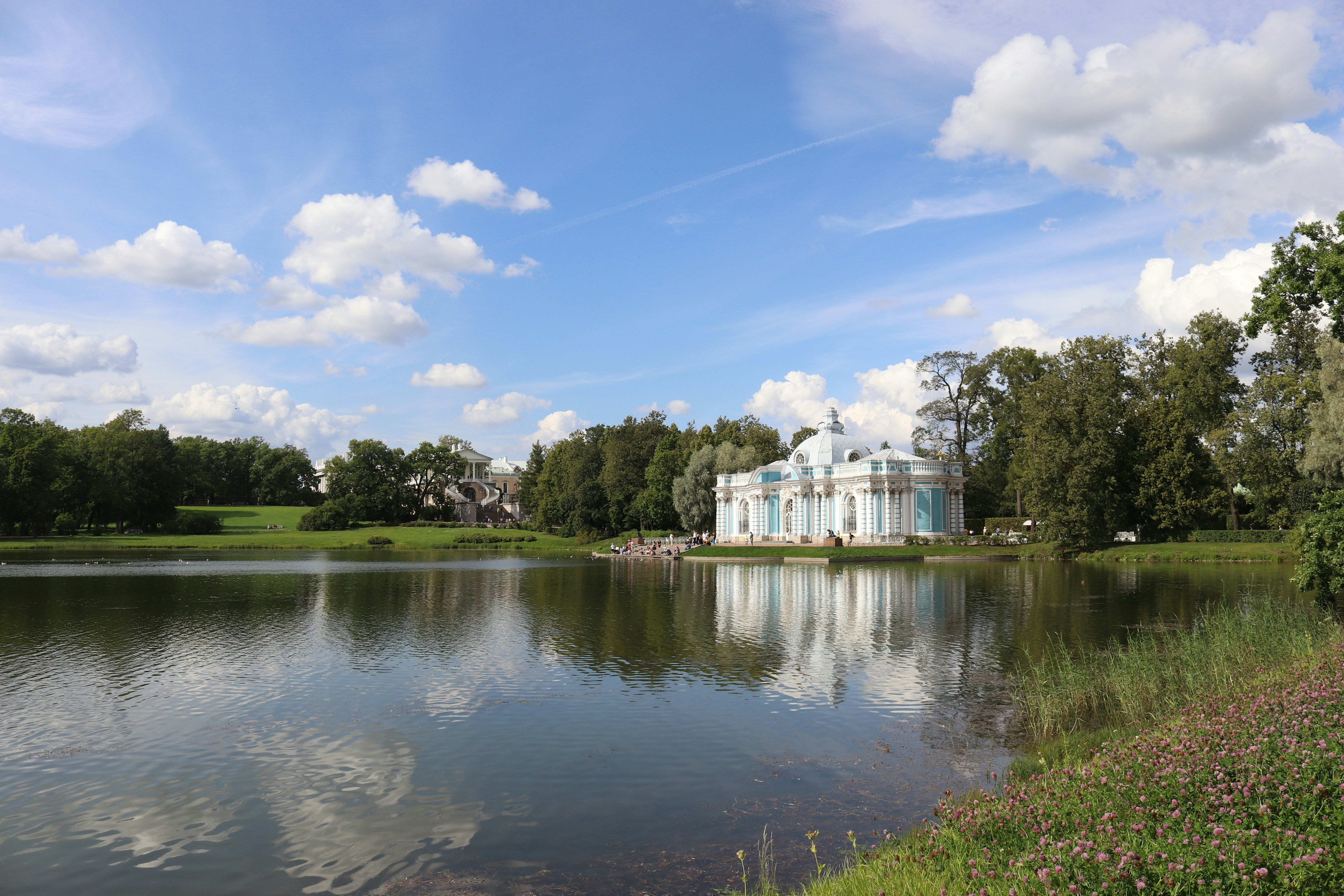 a house sits on the edge of a lake