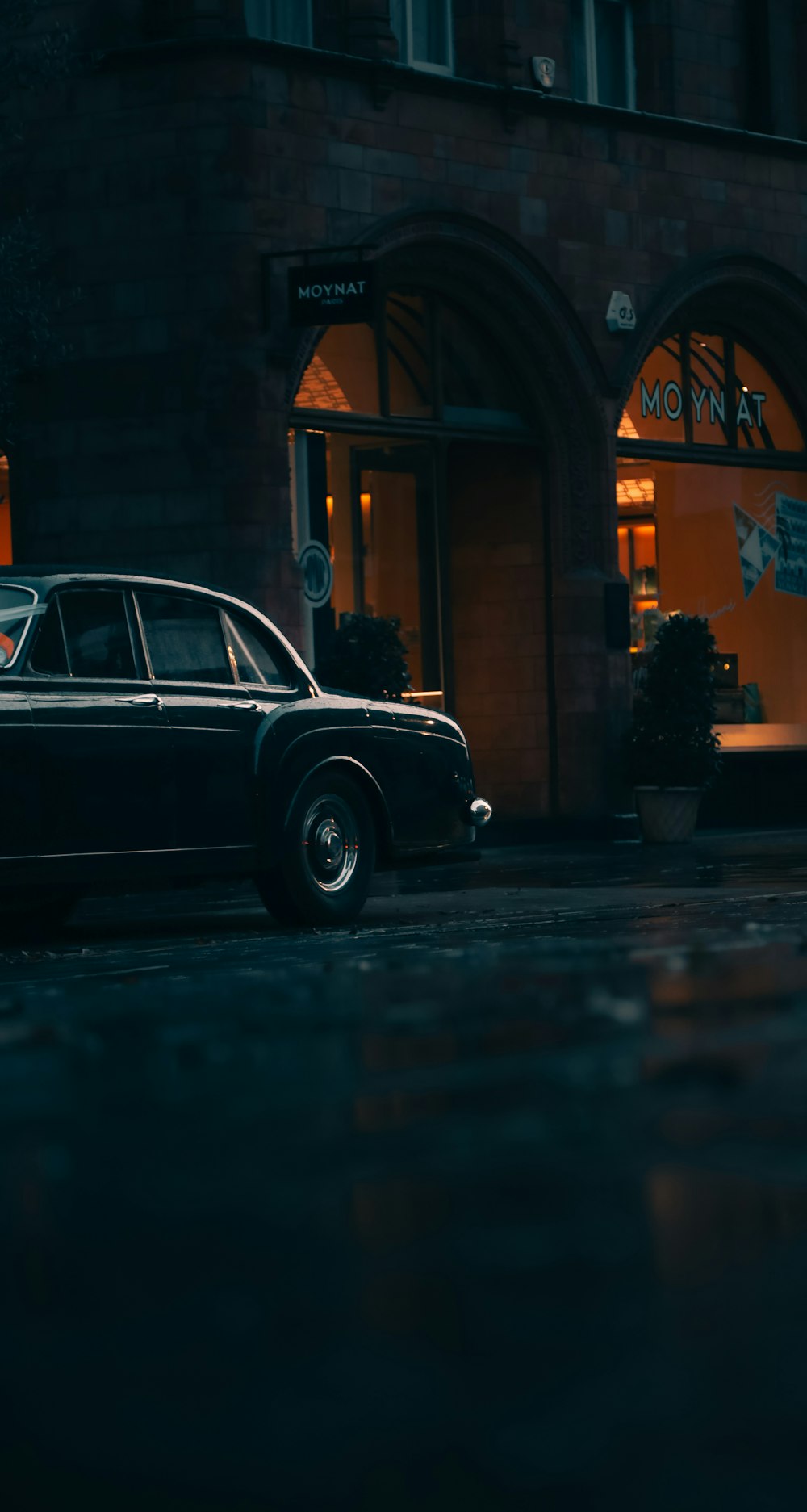 a black car parked in front of a building