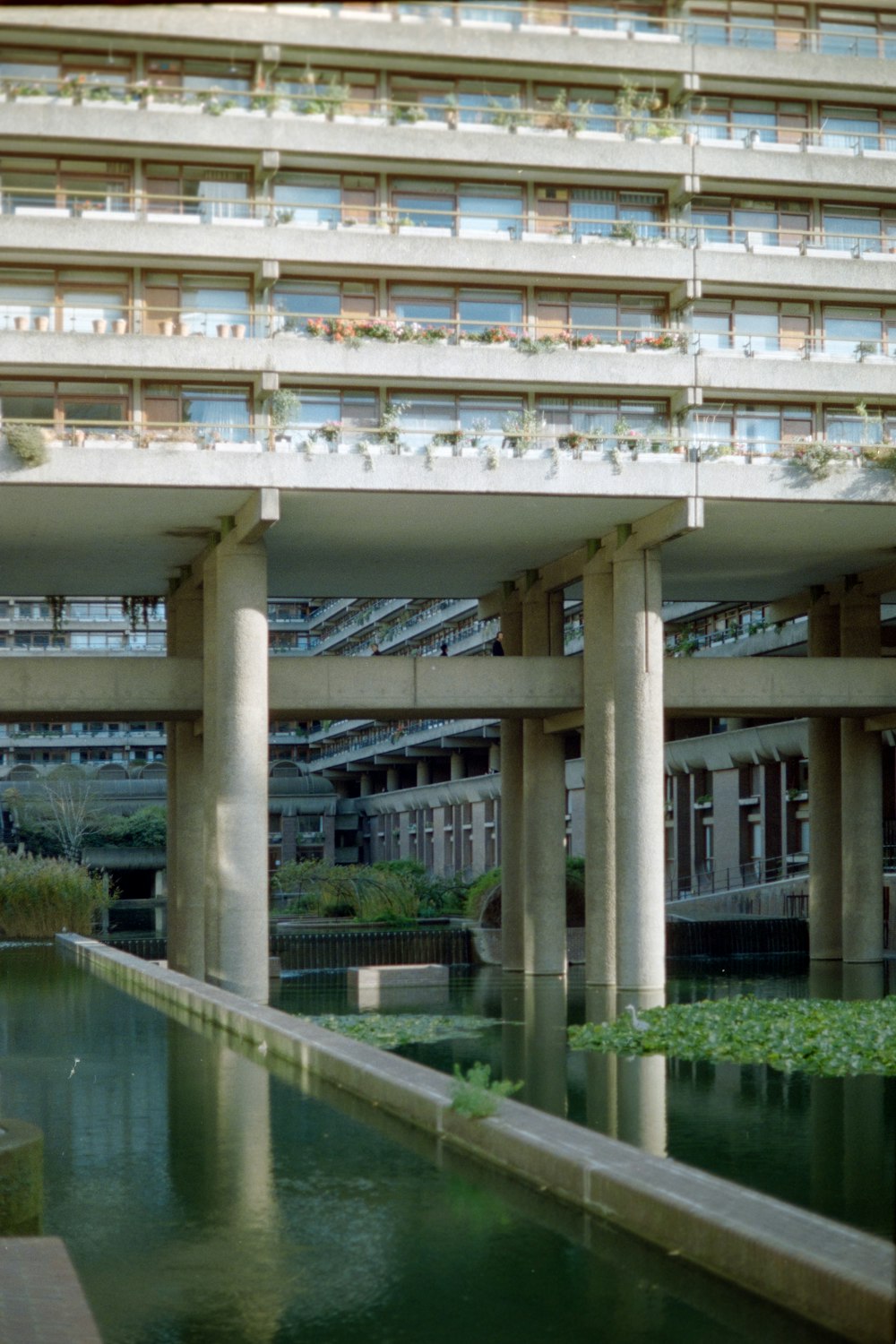 a large building with a pond in front of it