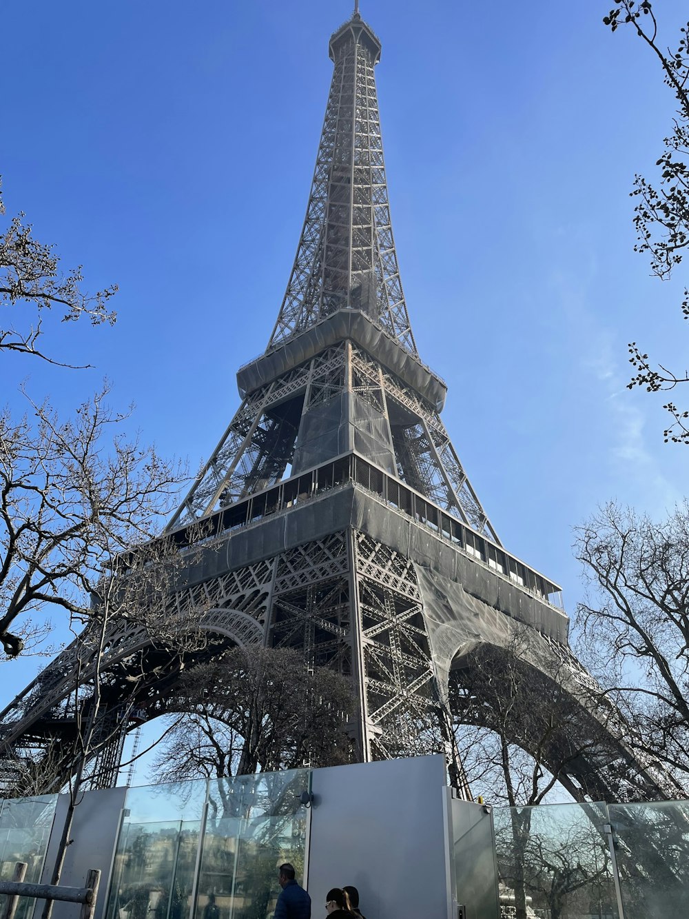 a man and a woman standing in front of the eiffel tower