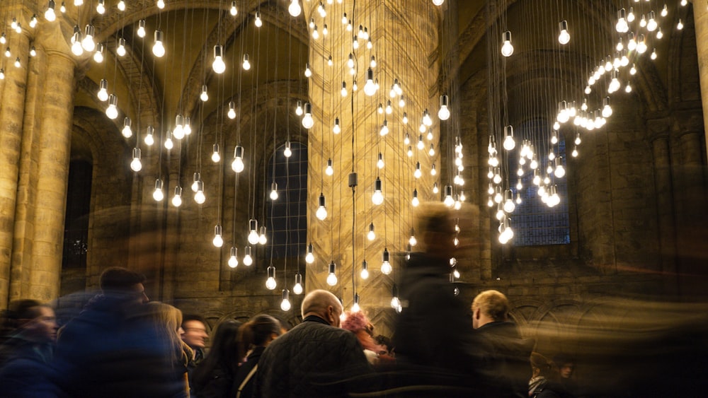 a large group of people standing around a cathedral