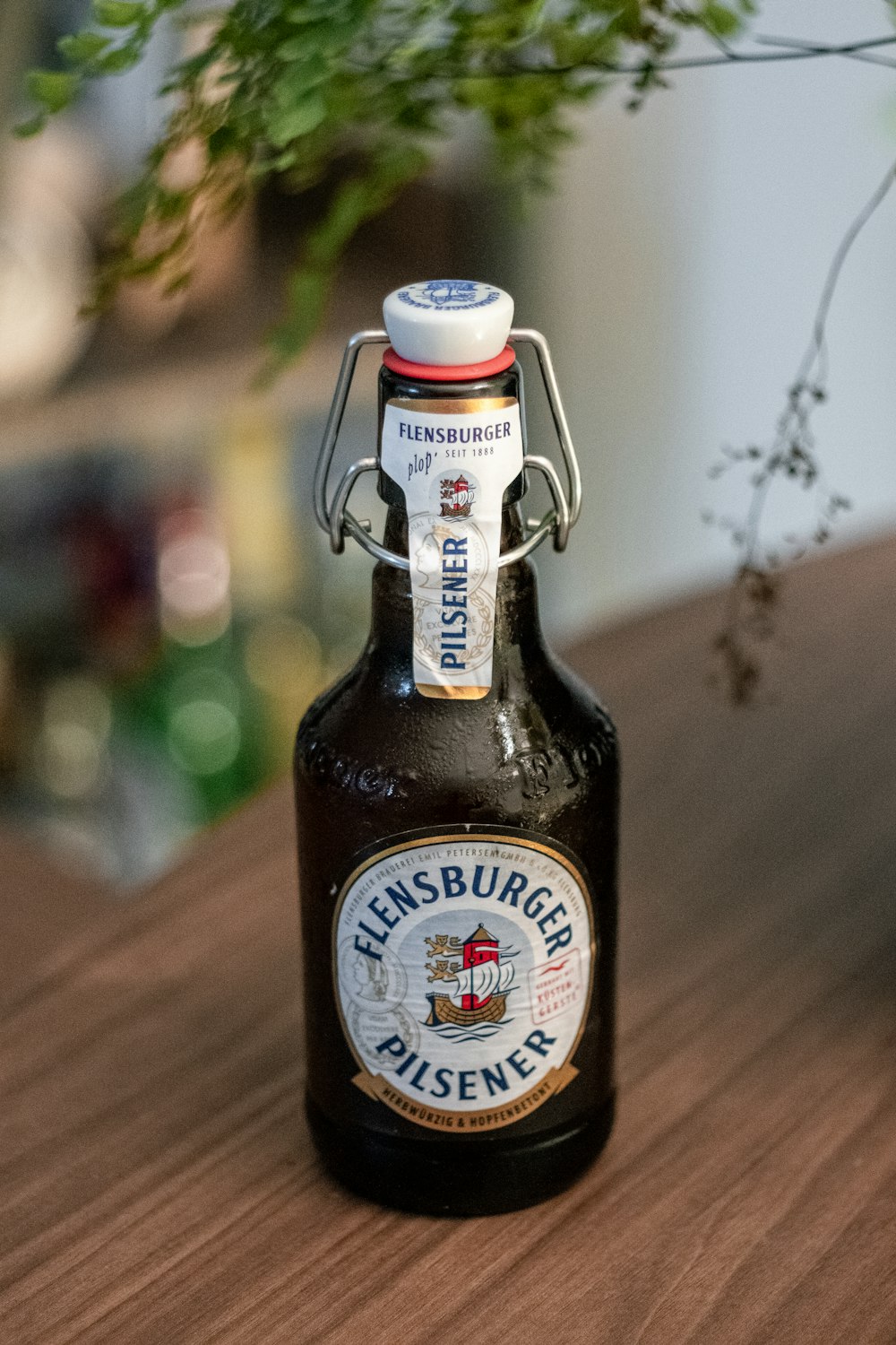 a bottle of beer sitting on top of a wooden table