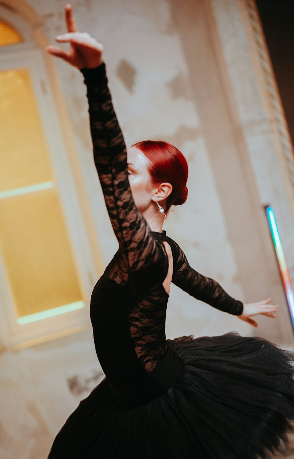 a woman in a black dress is dancing