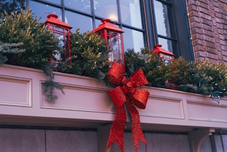 a red bow is tied to a window sill