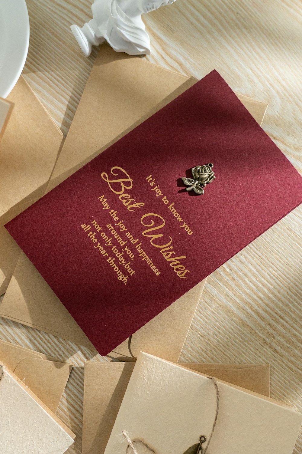 a red and gold wedding card on a table